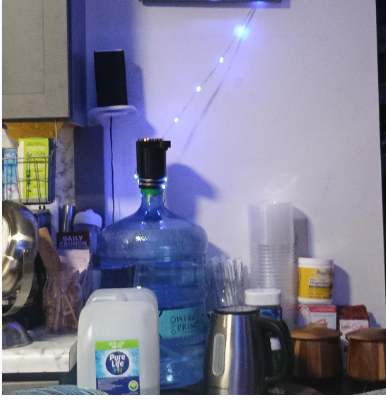 AquaLift product installed on a water gallon in a kitchen